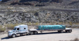 Cypress flatbed truck driving on scenic highway with freight