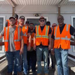 Cypress CDL School trainees and instructors standing together during CDL training