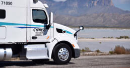 Cypress Truck Lines truck traveling on regional route near scenic landscape