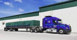 Cypress Truck Lines flatbed truck at facility with loaded freight