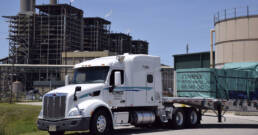 Cypress Truck Lines flatbed truck hauling industrial materials at job site